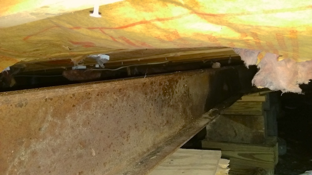 Floor support beam gap from foundation shifting.