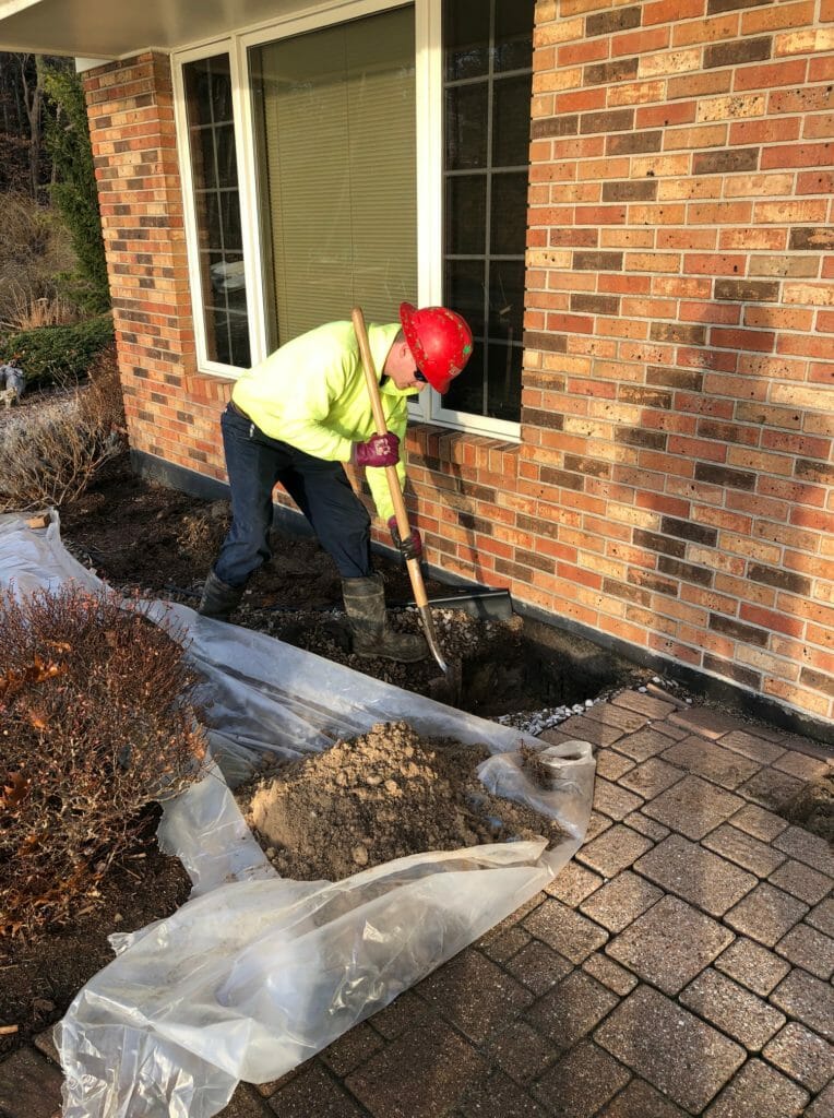 A Kent Foundation Repair worker overlooks a foundation repair job in Michigan.