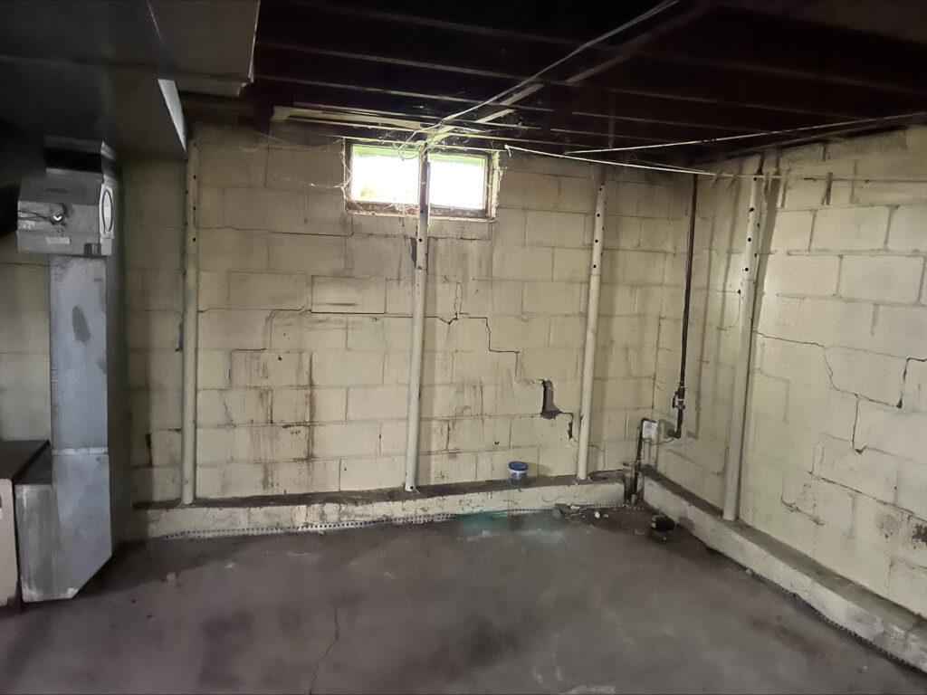 Image of a white cement wall in a basement.